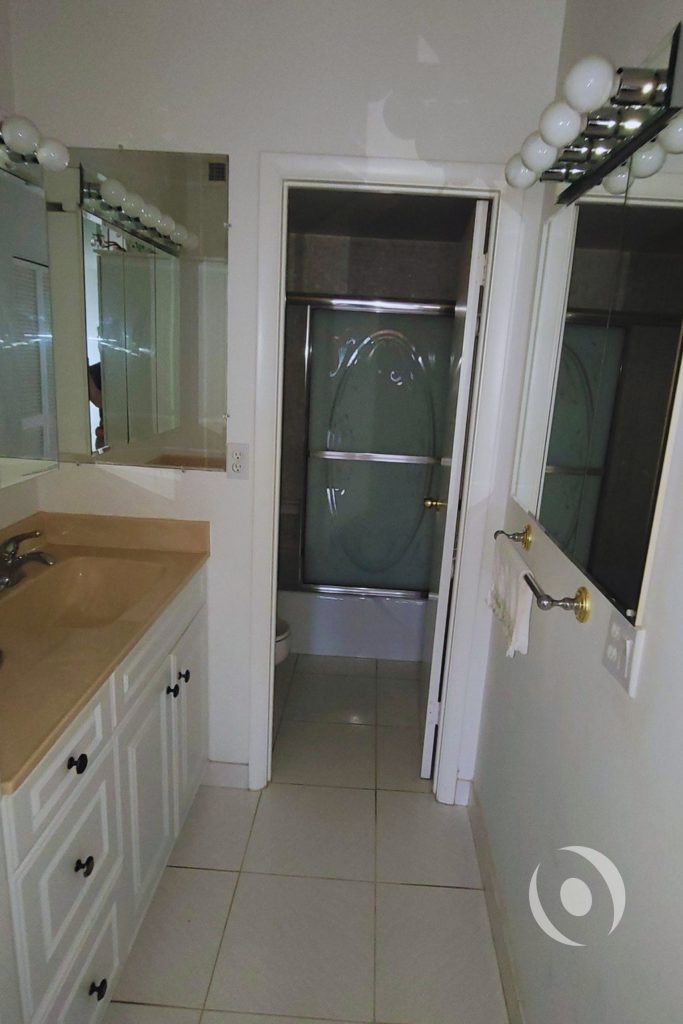 Before photo of outdated bathroom in oceanfront condominium prior to full plumbing and architectural renovation in Hallandale Beach Florida