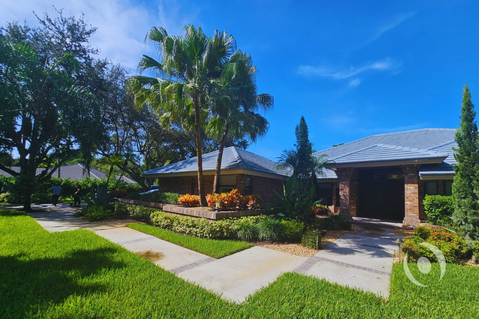 Existing single-story luxury brick residence in Parkland, Florida before two-story addition and full interior renovation designed and engineered by NOHMIS, showing original roofline, mature landscaping, and brick facade prior to construction