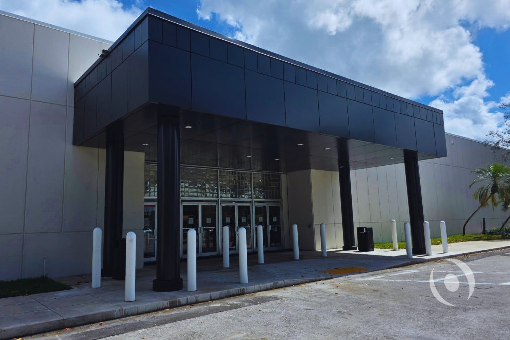Completed commercial canopy entrance with steel columns and aluminum composite panel cladding — structural engineering by NOHMIS, Coral Springs, FL