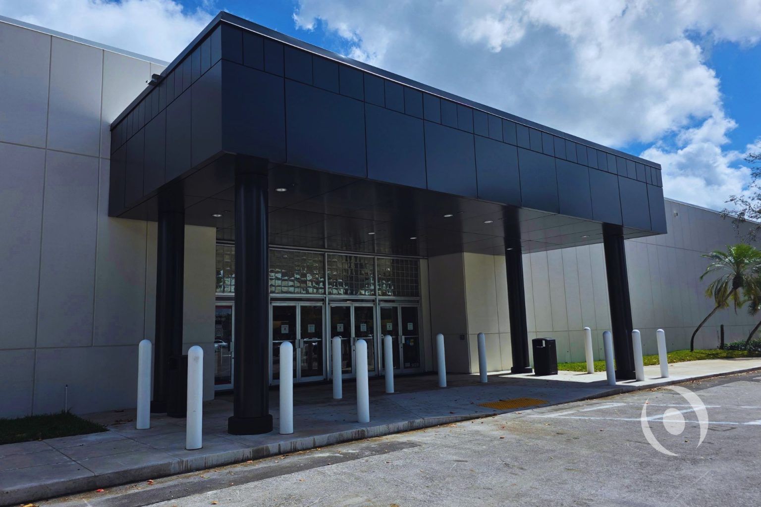 Completed commercial canopy entrance with steel columns and aluminum composite panel cladding — structural engineering by NOHMIS, Coral Springs, FL
