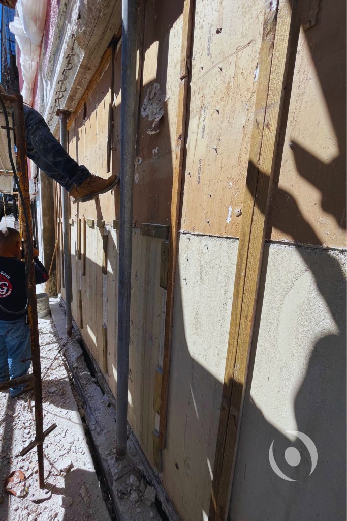 Active construction scaffolding and wall formwork installed during NOHMIS-supervised commercial concrete restoration and structural repair project in Broward County, Florida