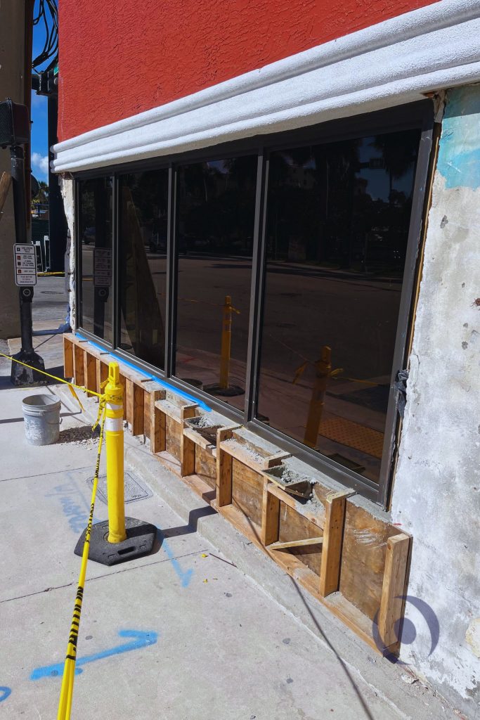 Timber formwork installed for new reinforced concrete tie beam and CMU wall reconstruction during commercial building structural repair in Hollywood, Florida