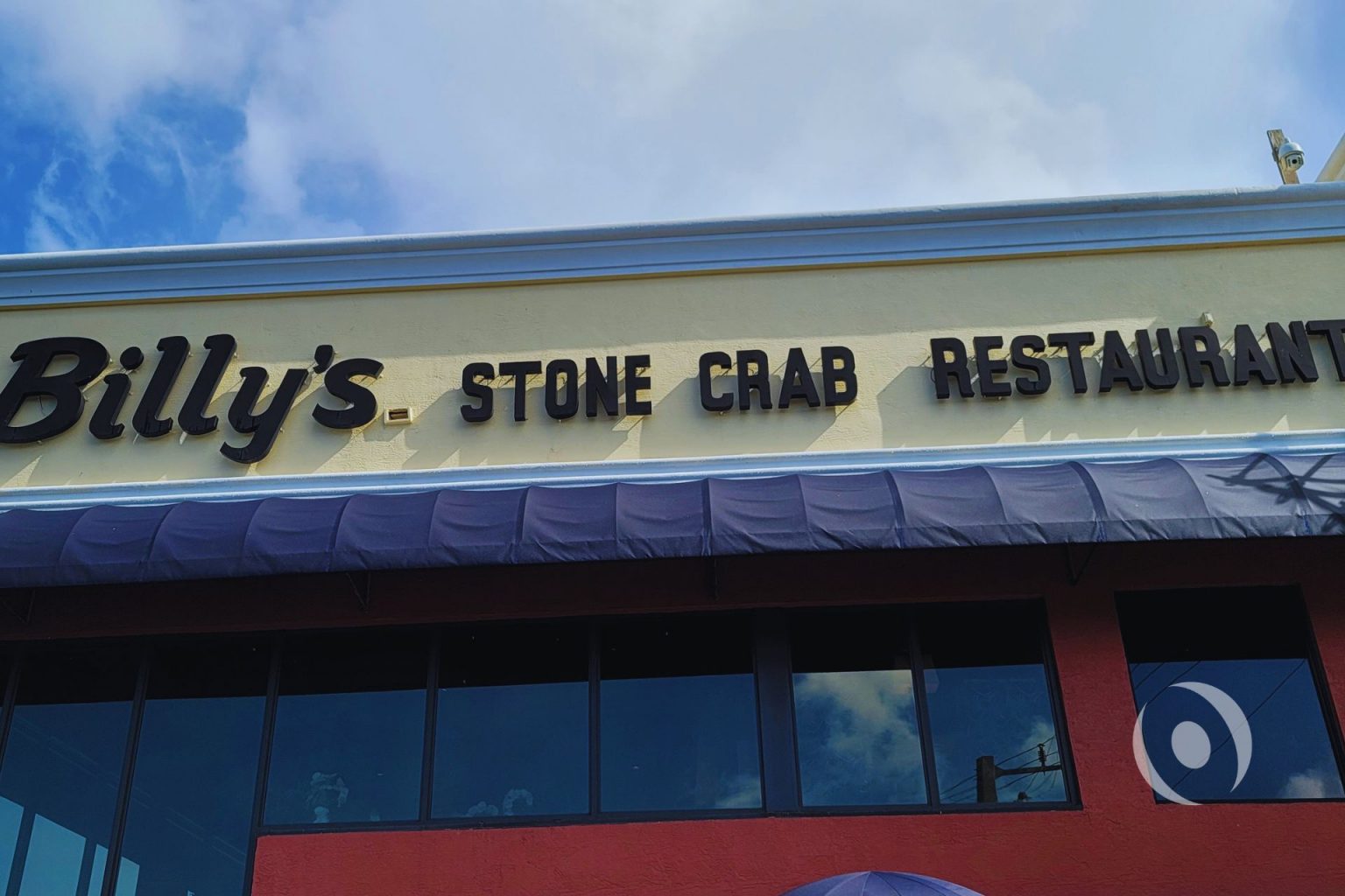 Exterior signage of commercial restaurant in Hollywood, Florida before NOHMIS-designed structural concrete restoration and architectural exterior renovation, showing original building facade condition