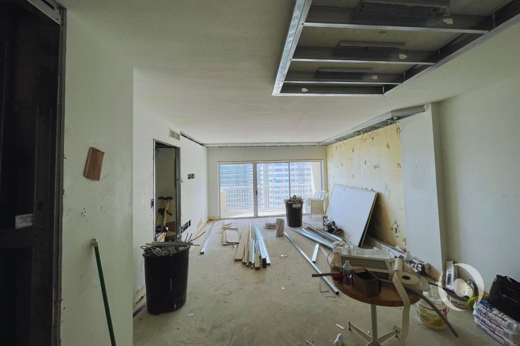 Mid-construction view of dropped ceiling metal stud framing and electrical rough-in during high-rise condominium renovation in South Florida by NOHMIS