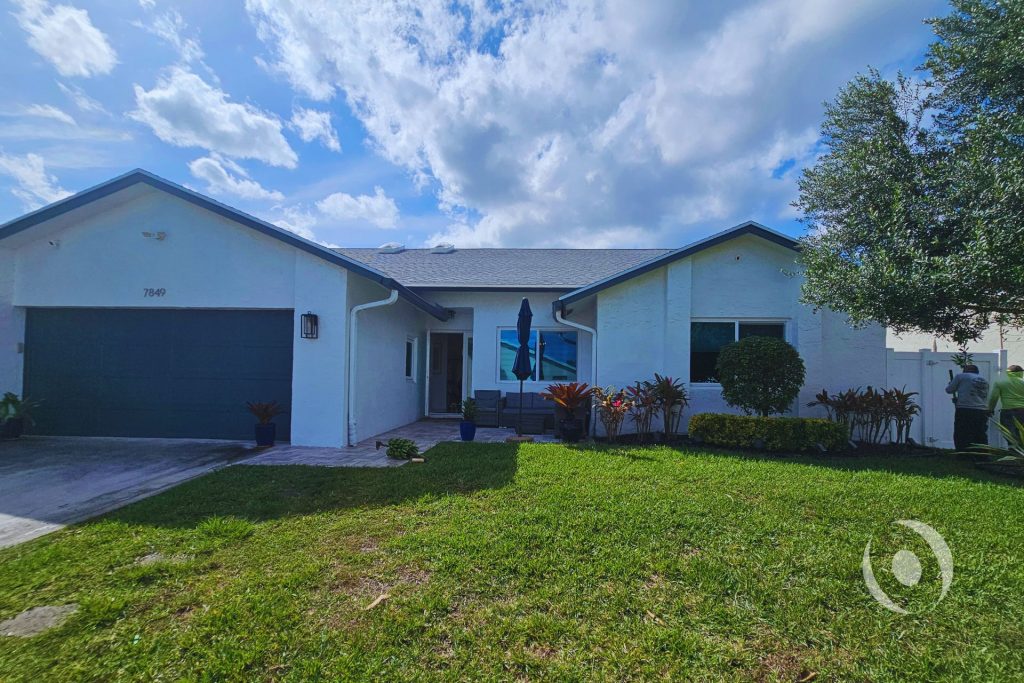 Existing conditions exterior view of a single-family home in Boca Raton, Florida prior to residential addition, garage conversion, and full interior renovation designed and engineered by NOHMIS