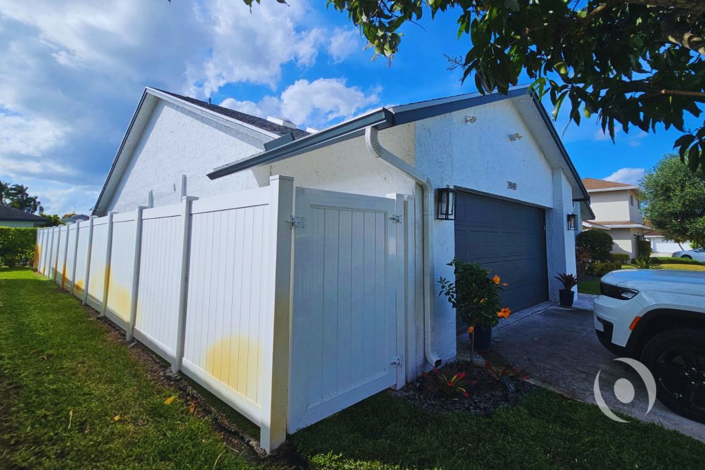 Side elevation view of existing garage and fence line documented during pre-design site assessment for a permitted garage conversion and residential addition project in Boca Raton, Florida by NOHMIS