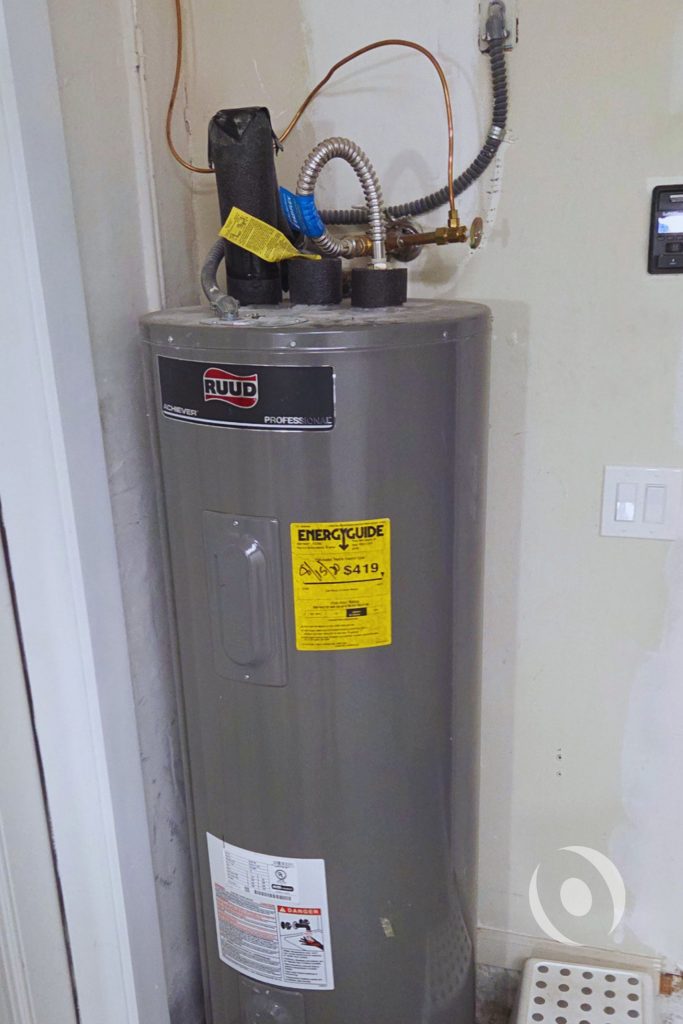 Existing Ruud water heater documented during plumbing inspection prior to new 65-gallon electric water heater design and PEX supply system redesign for a Boca Raton residential renovation
