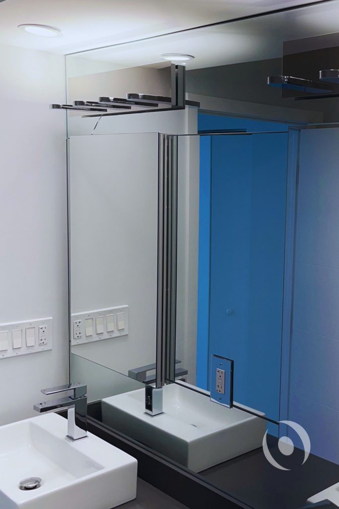 Renovated master bathroom with double vessel sinks modern fixtures and engineered plumbing layout in high-rise condominium Hallandale Beach Florida