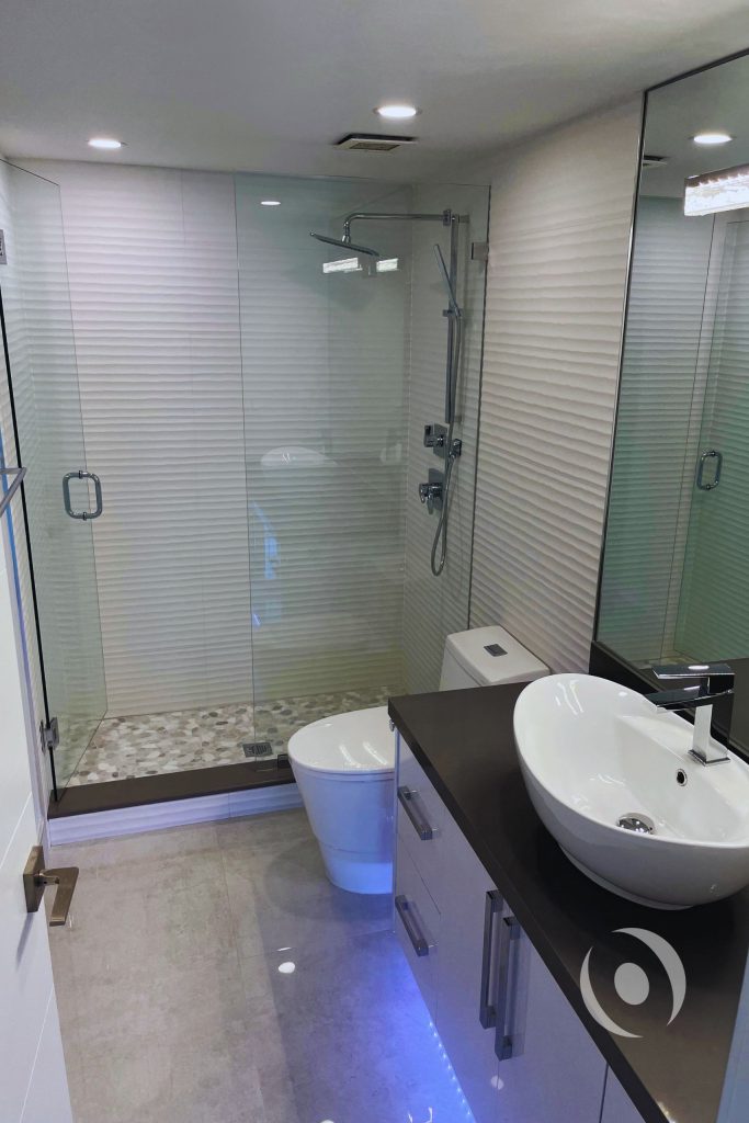 Completed master bathroom renovation featuring walk-in shower recessed lighting and full plumbing engineering by NOHMIS in Hallandale Beach Broward County