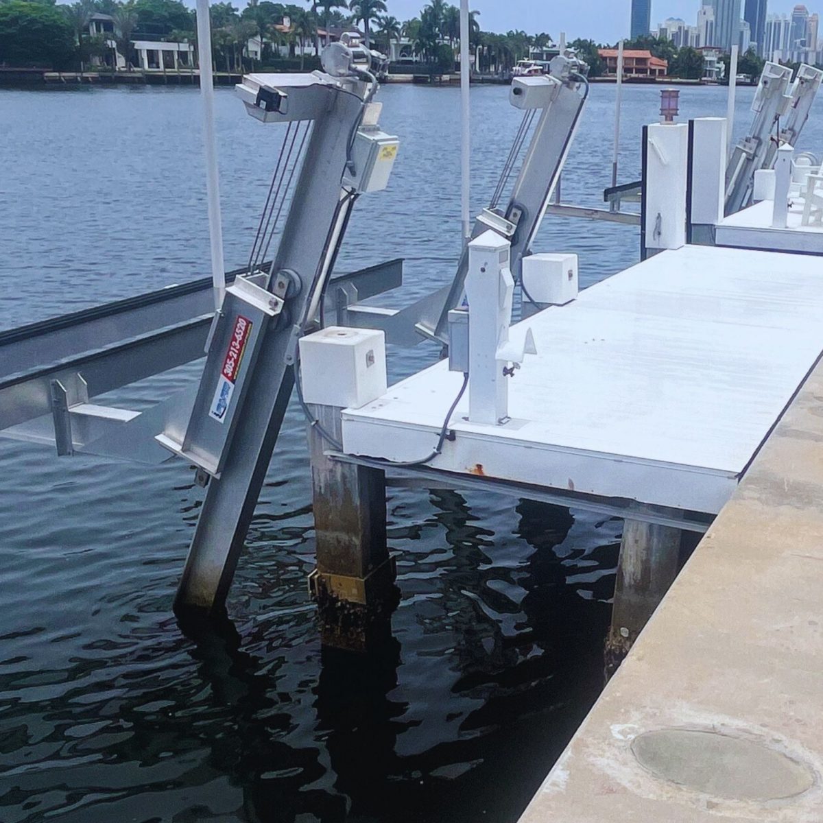 Completed seawall and dock system engineered by NOHMIS in South Florida, showing reinforced concrete seawall and waterfront stability improvements