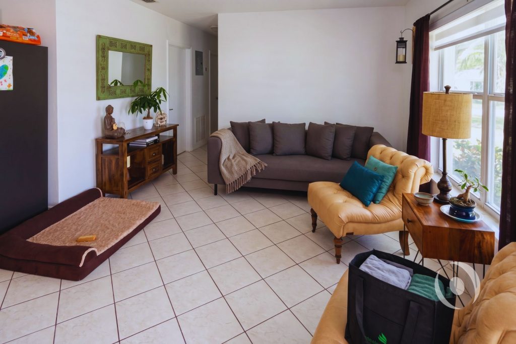 Interior living area of completed home addition in Miami-Dade County showing open floor plan, large windows for natural light, and tile flooring designed by NOHMIS South Florida