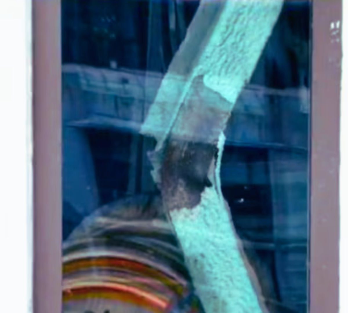 Buckled steel beam at a Midtown Manhattan construction site showing significant structural deformation during an active engineering safety investigation.