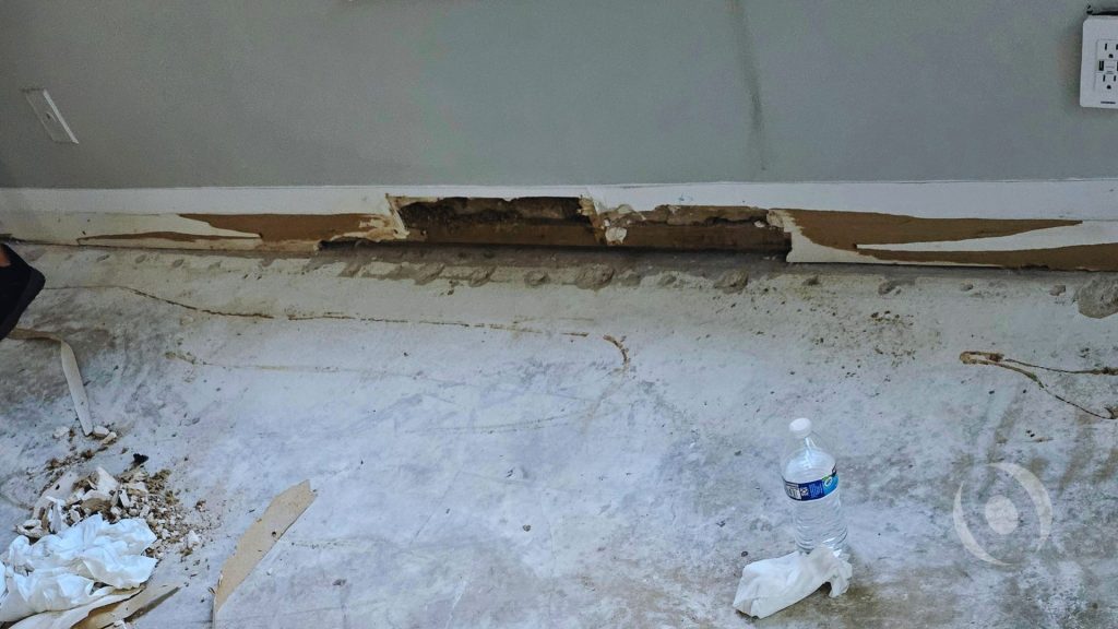 Water intrusion through a concrete slab foundation in a South Florida home caused by hydrostatic pressure and saturated soil conditions.  