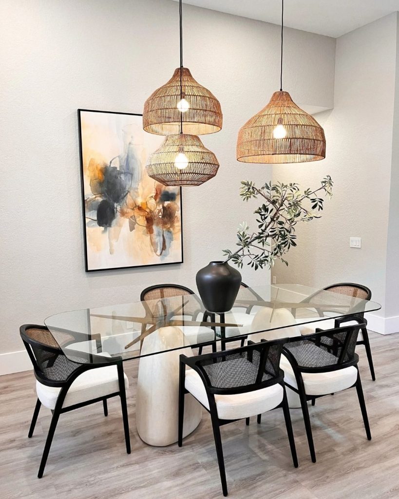 Modern open-concept kitchen design with white cabinetry, waterfall stone island, black fixtures, pendant lighting, integrated appliances, and minimalist finishes.